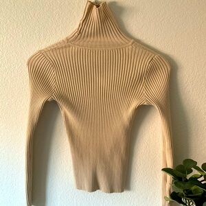 Woman’s tight fitting cream turtleneck